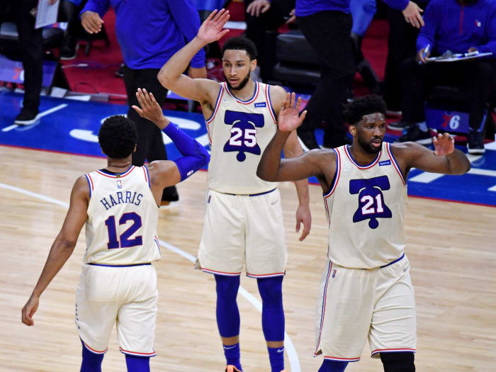 Apr 14, 2021; Philadelphia, Pennsylvania, USA; Philadelphia 76ers forward Tobias Harris (12) celebrates with guard Ben Simmons (25) and center Joel Embiid (21) against the Brooklyn Nets during the second quarter at Wells Fargo Center.